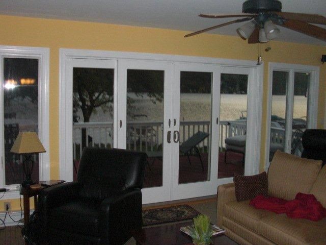 A living room with sliding glass doors and a ceiling fan