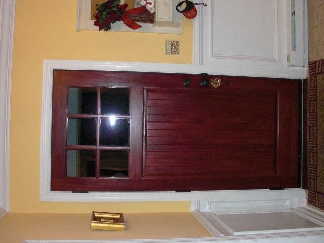 A red door with a window and a sign that says love