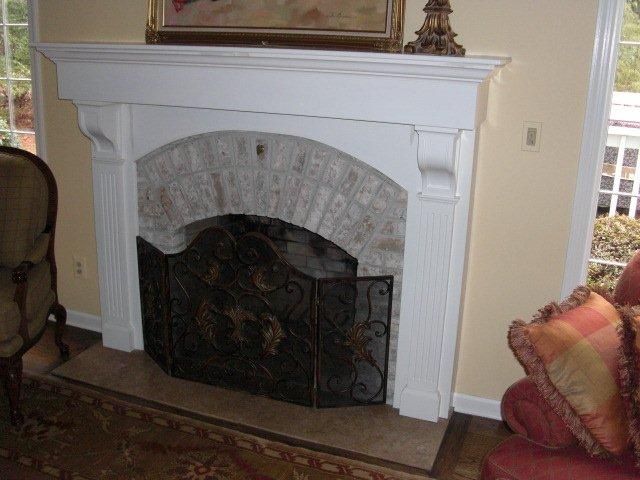 A living room with a fireplace and a chair