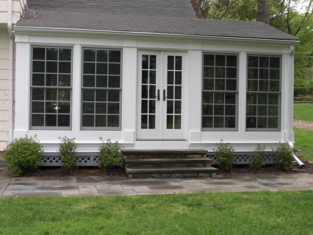 A white house with a lot of windows and doors