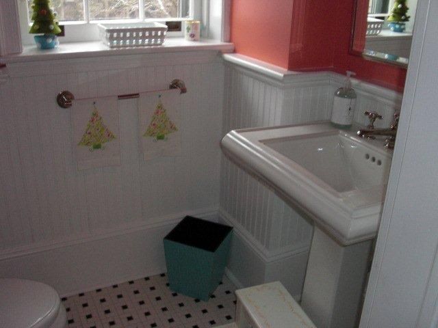 A bathroom with a sink a toilet and a window