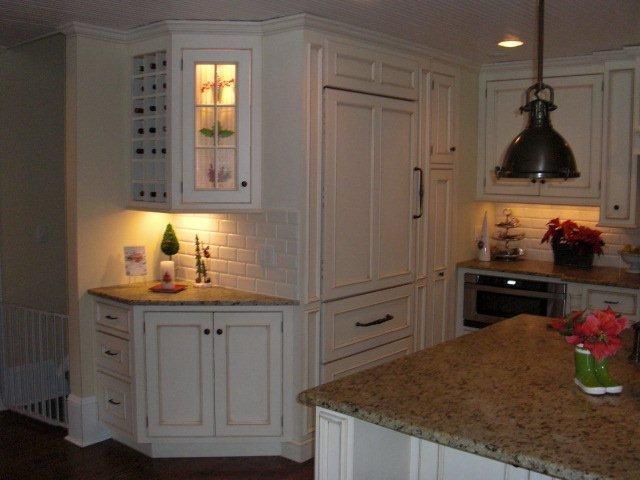 A kitchen with white cabinets and granite counter tops
