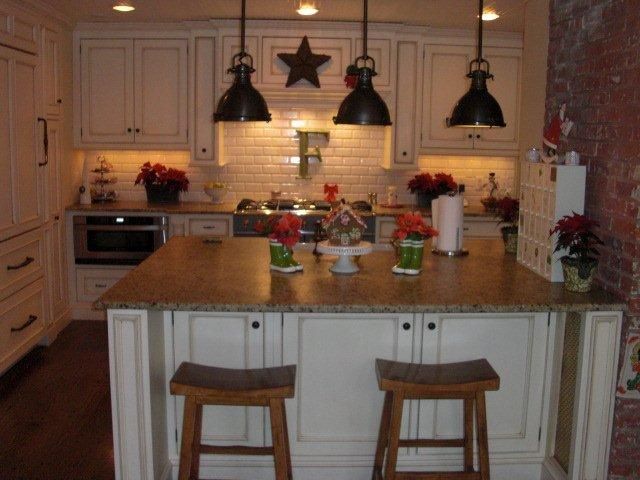 A kitchen with white cabinets and granite counter tops