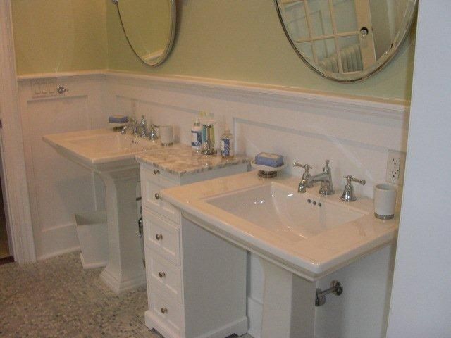 A bathroom with two sinks and two mirrors