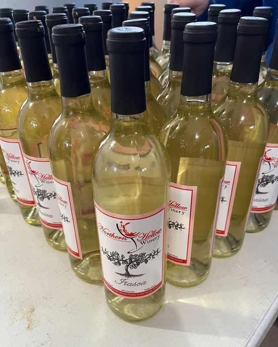 A bunch of bottles of wine are sitting on a table