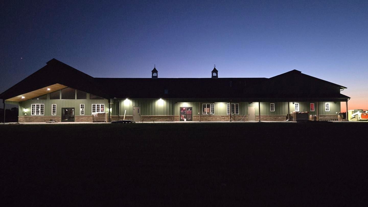 A group of people are standing next to a row of atvs on a dirt road.