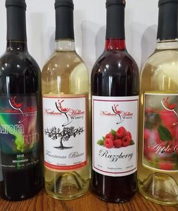 Four wine bottles in a row, with different labels and colors.