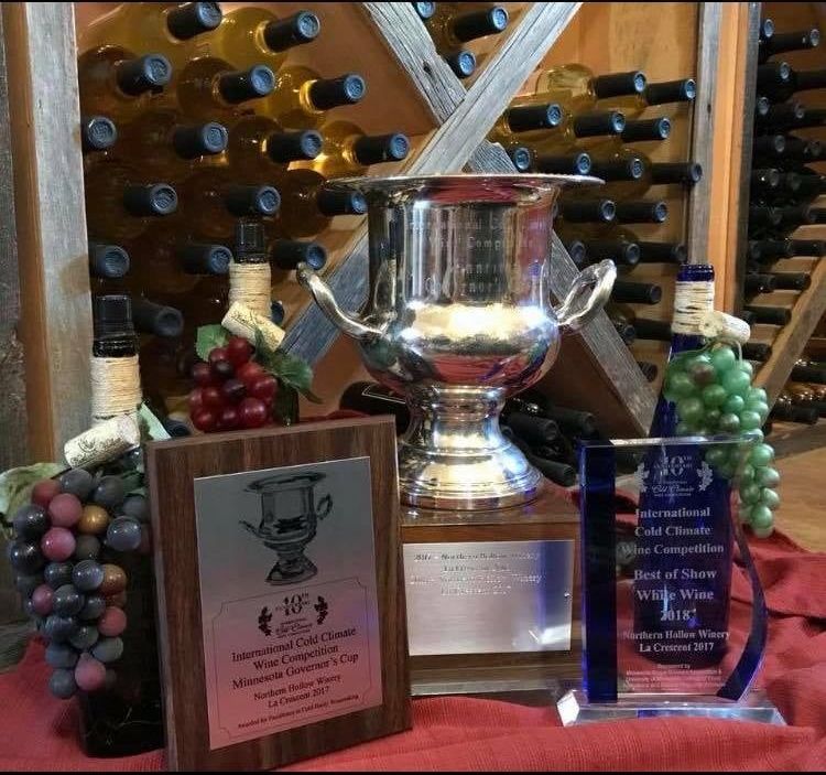 A wine cellar with trophies and bottles of wine