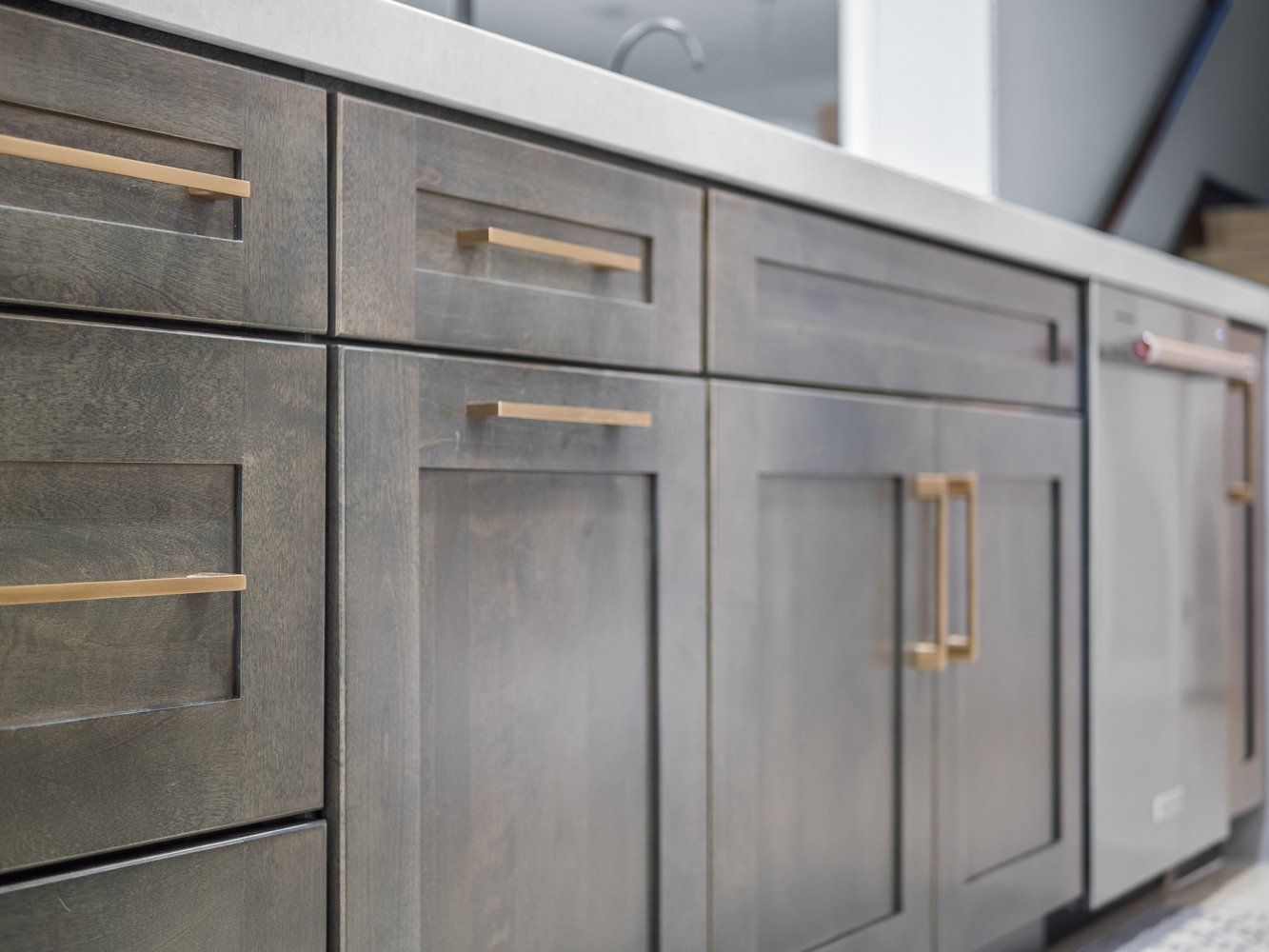 Brown rustic shaker style cabinets paired with white calacatta quartz countertop in kitchen remodel in Aliso Viejo, CA