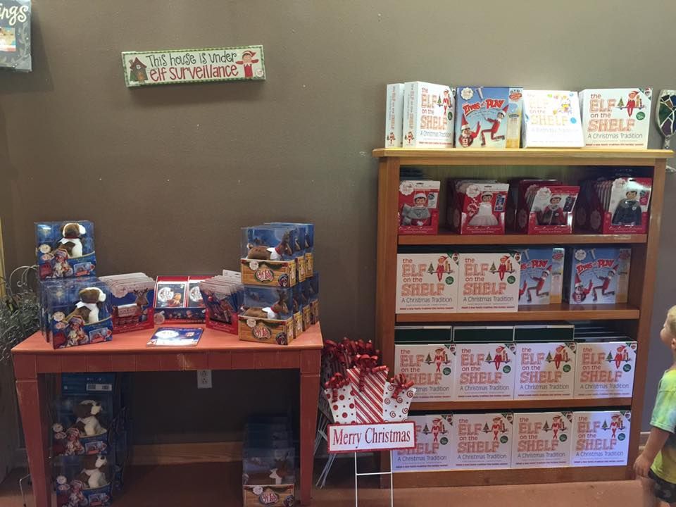Christmas retail display of Elf on the Shelf books and related merchandise, interior store.