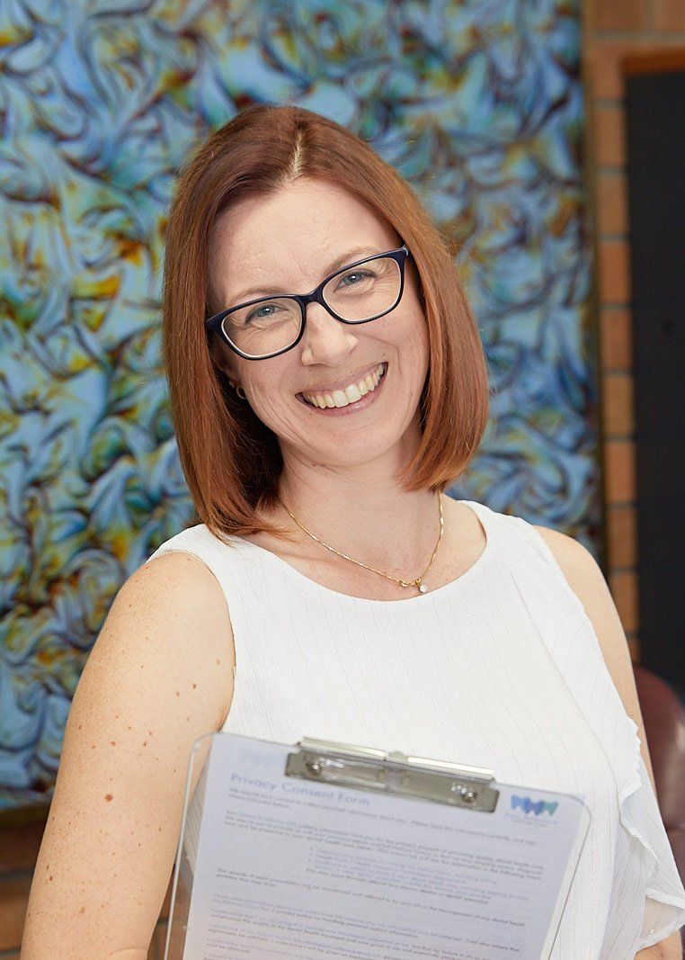 Smiling Office Manager with Clipboard — Bromley's Denture Clinic in Tweed Heads South, NSW