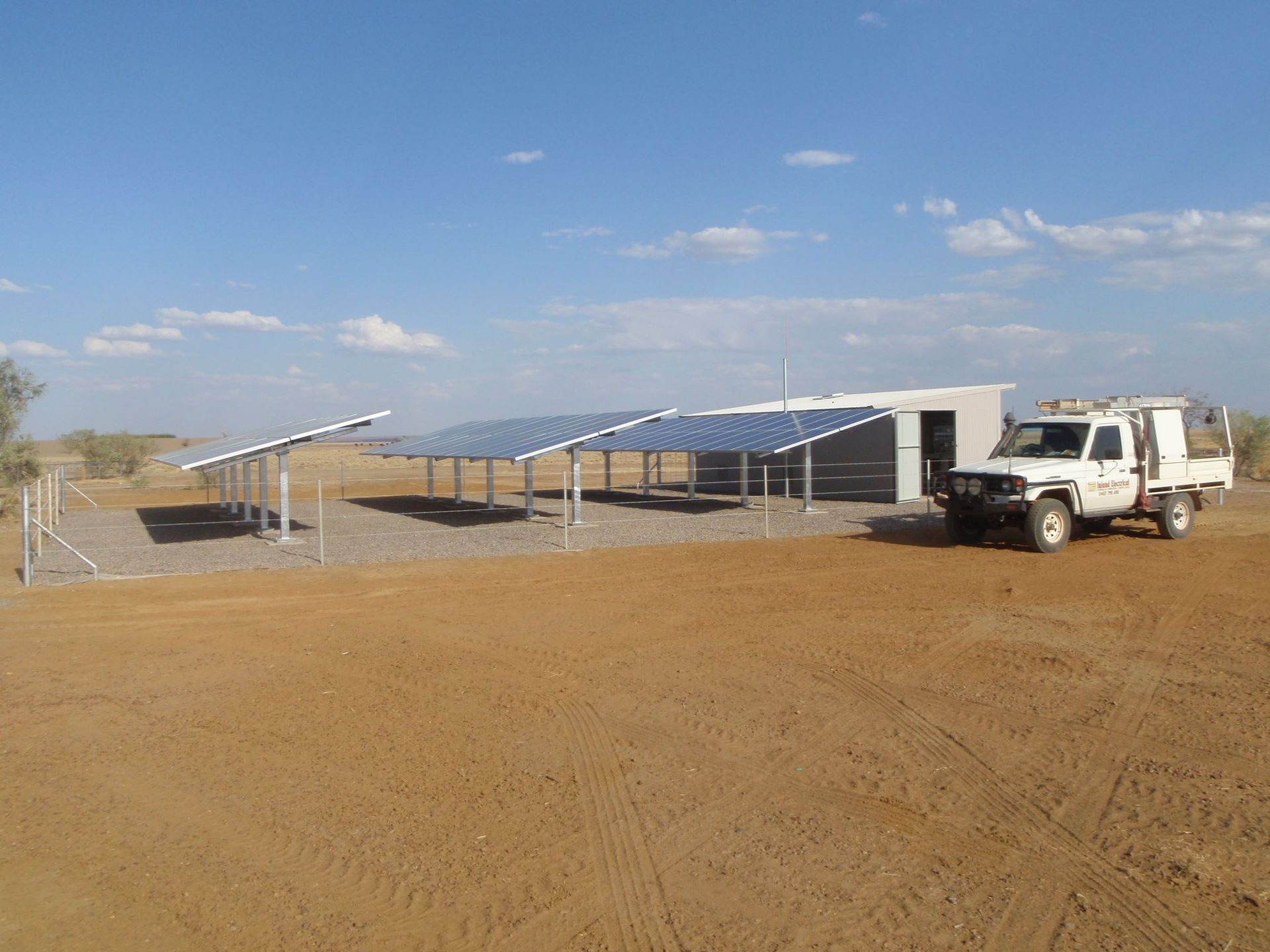 Solar Panels In A Fenced Area and Sky — Inland Electrical in Humpty Doo, NT