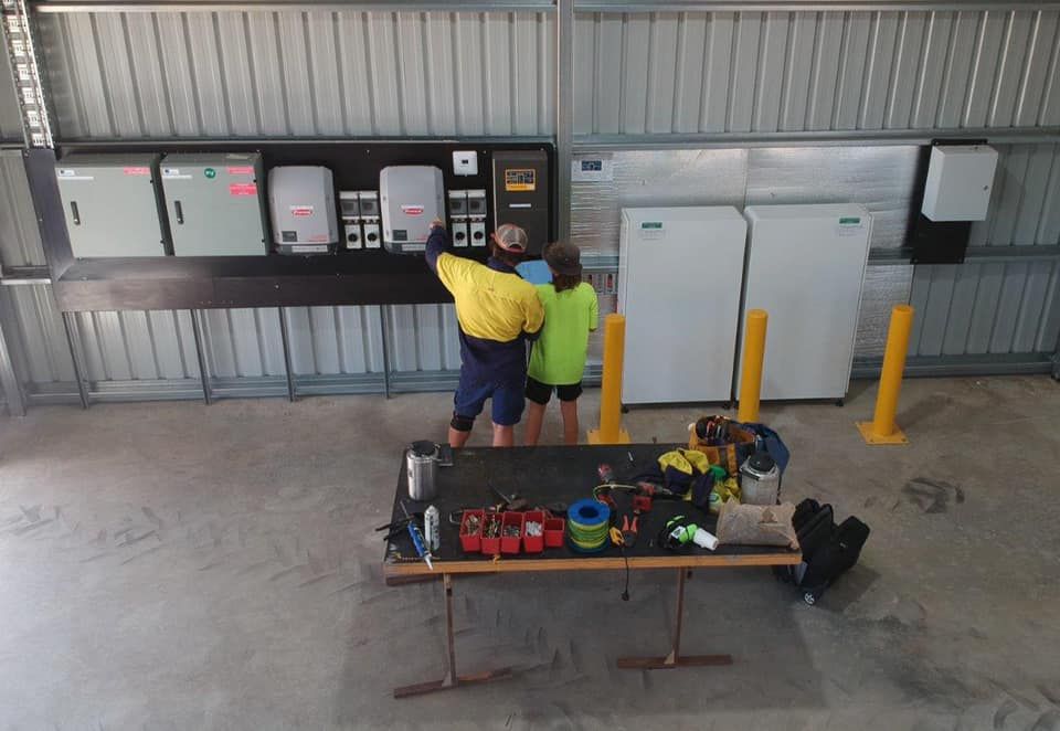Two Men Standing Near A Power Board — Inland Electrical in Humpty Doo, NT
