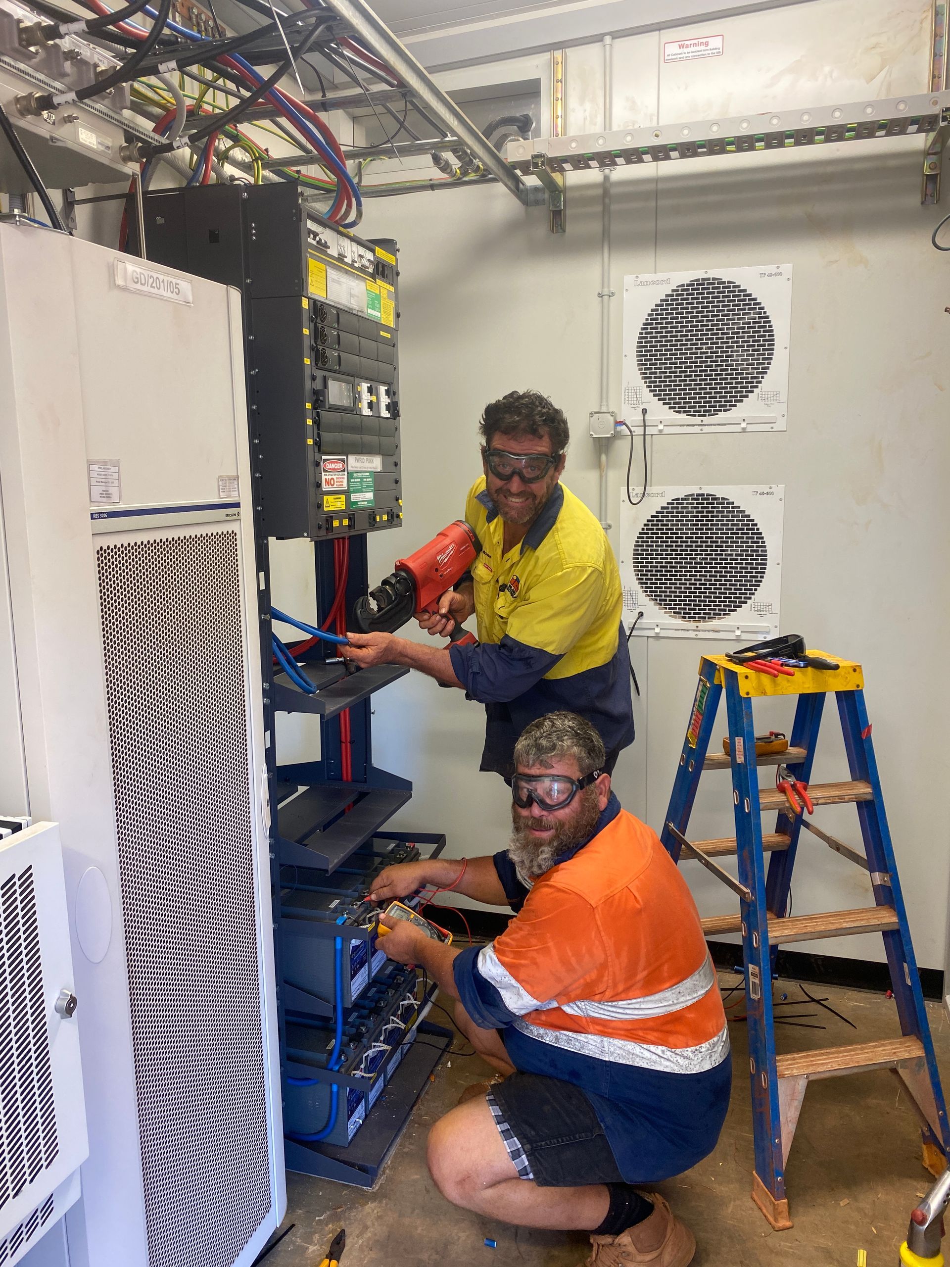 Two Electricians Working On Wire— Inland Electrical in Humpty Doo, NT