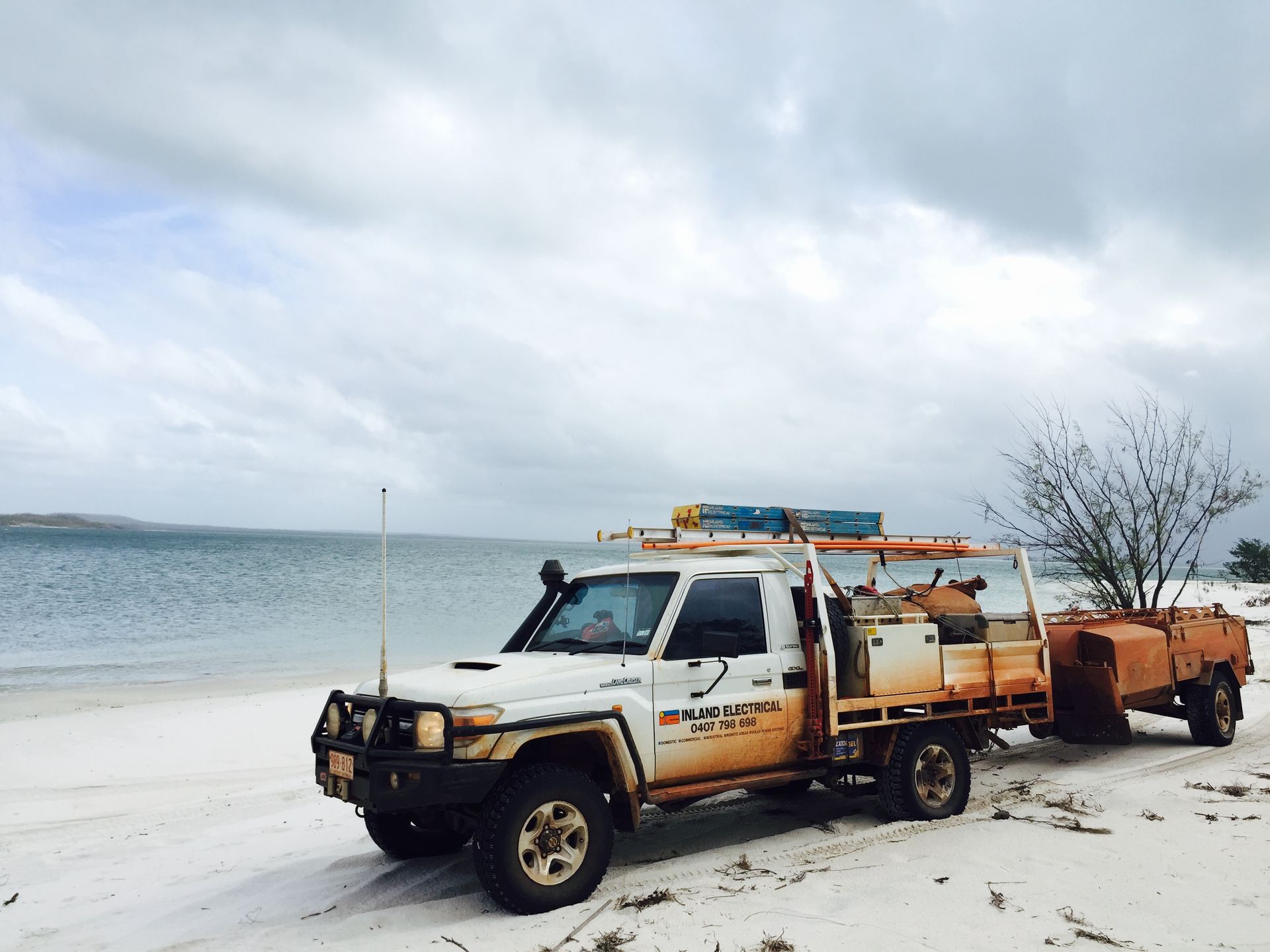 Truck On White Sand Next To Ocean — Inland Electrical in Humpty Doo, NT