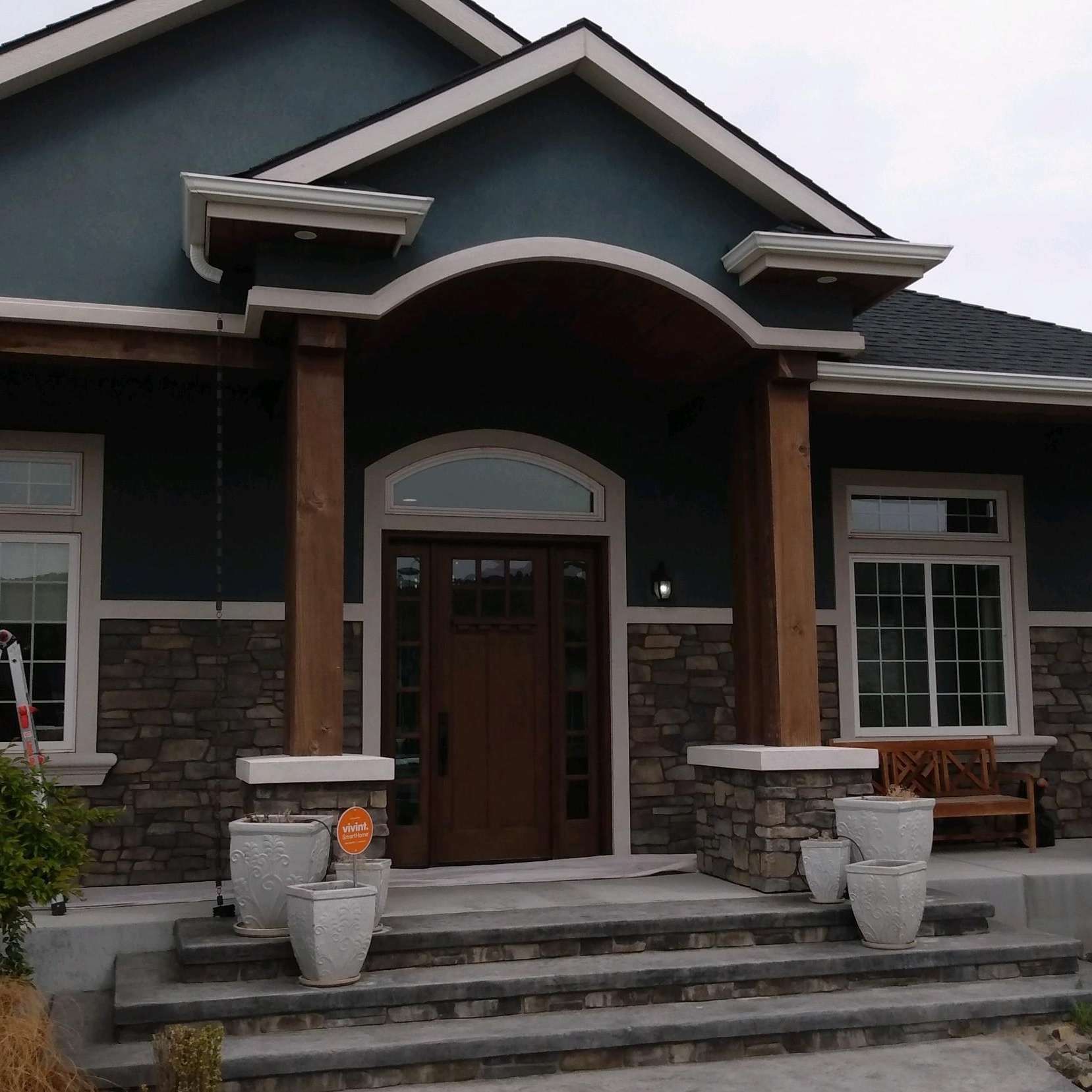 A blue house with a wooden door and steps
