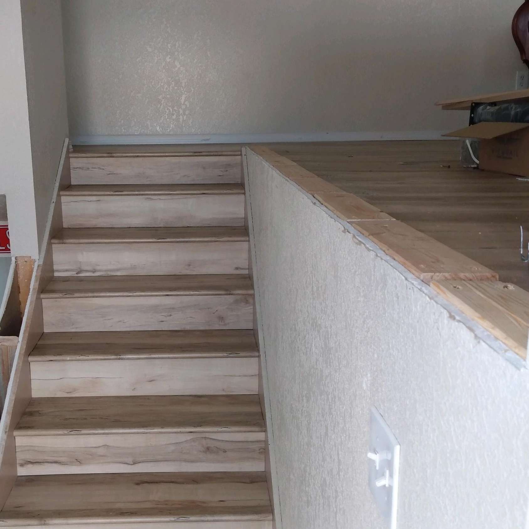 A set of wooden stairs leading up to the second floor of a house