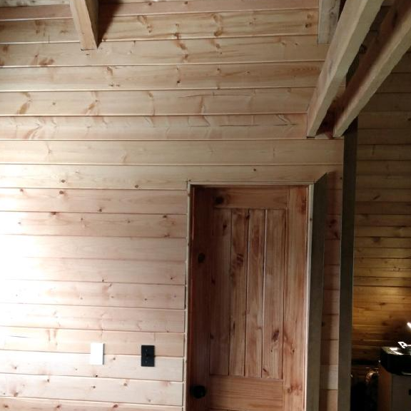 A room with wood paneling and a door in it