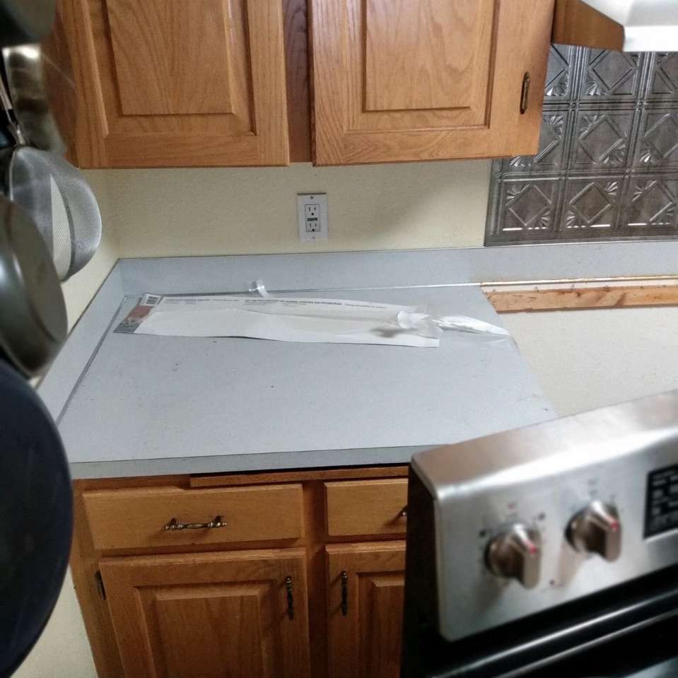 A kitchen with wooden cabinets and a stove top oven