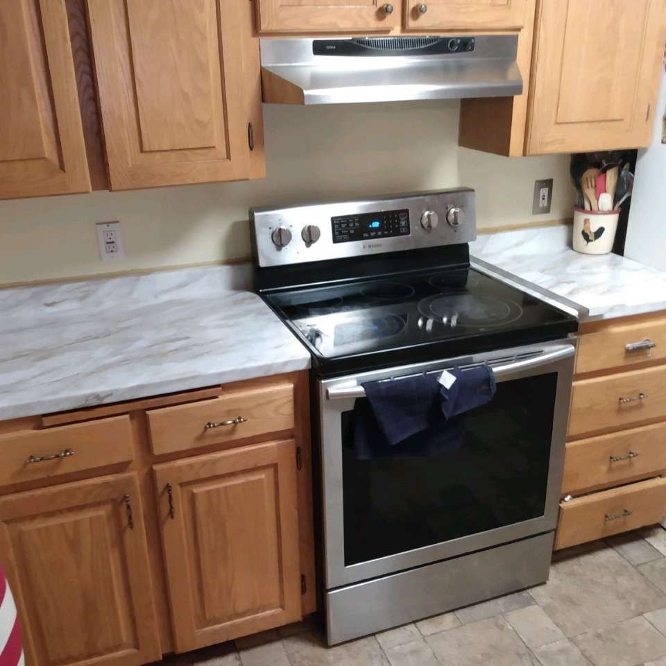 A kitchen with stainless steel appliances and wooden cabinets