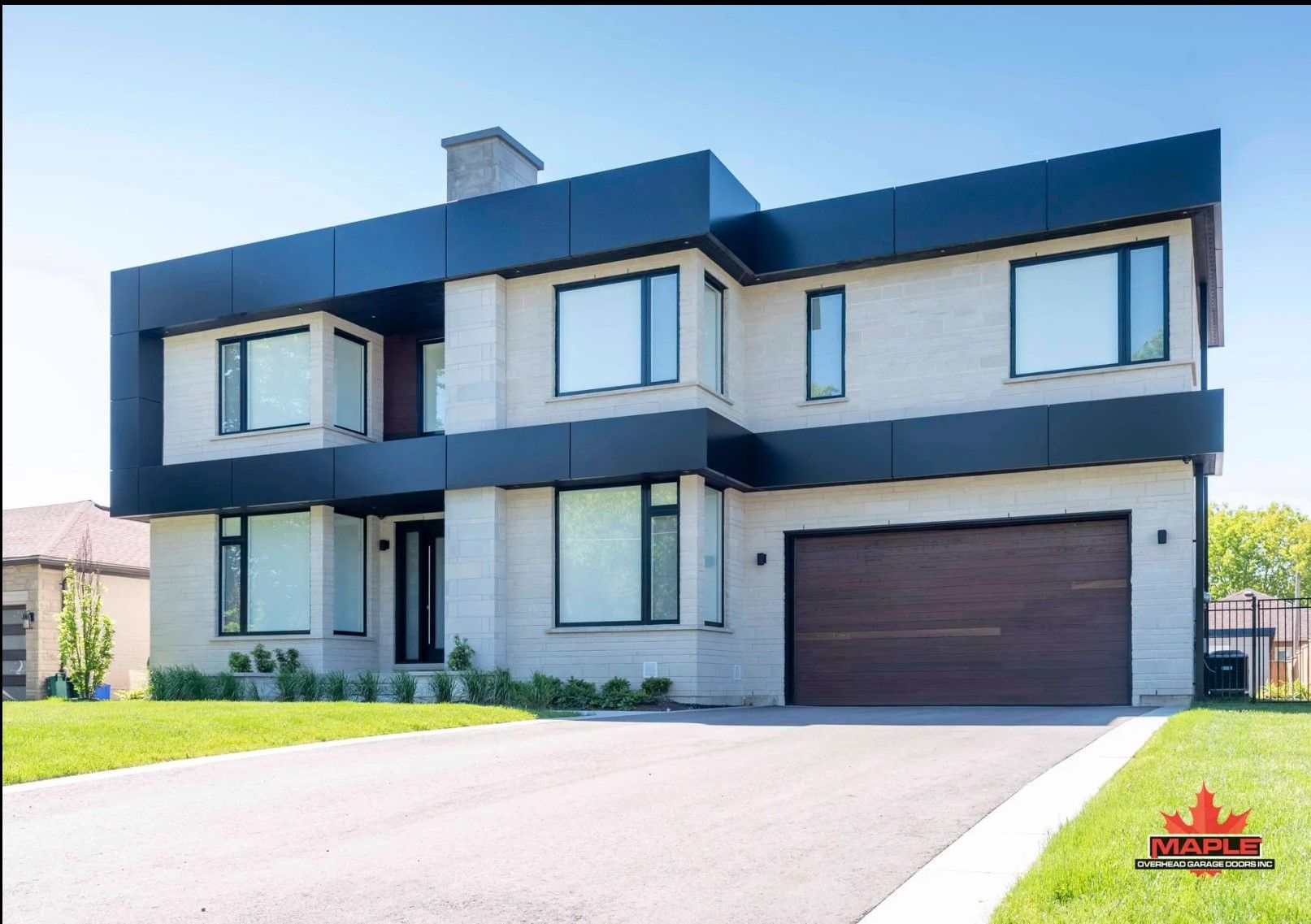 A large house with a garage and a lot of windows