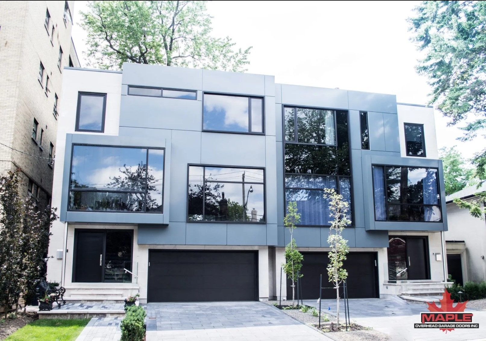 A large building with a lot of windows and black garage doors