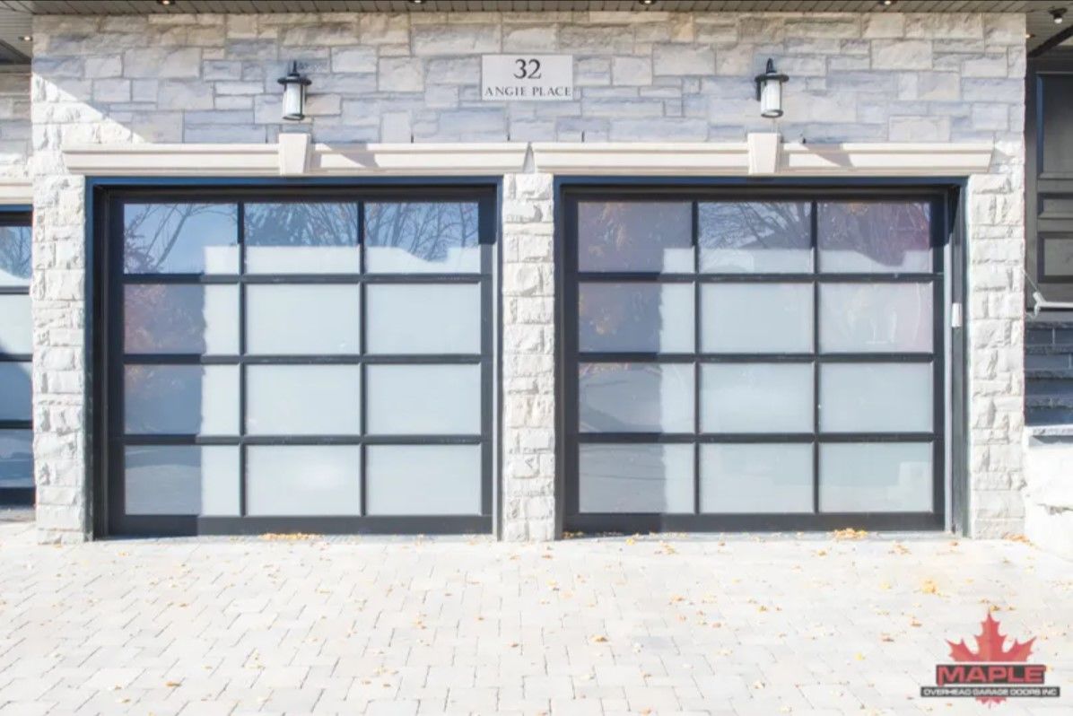 A brick building with two garage doors and the number 32 on it