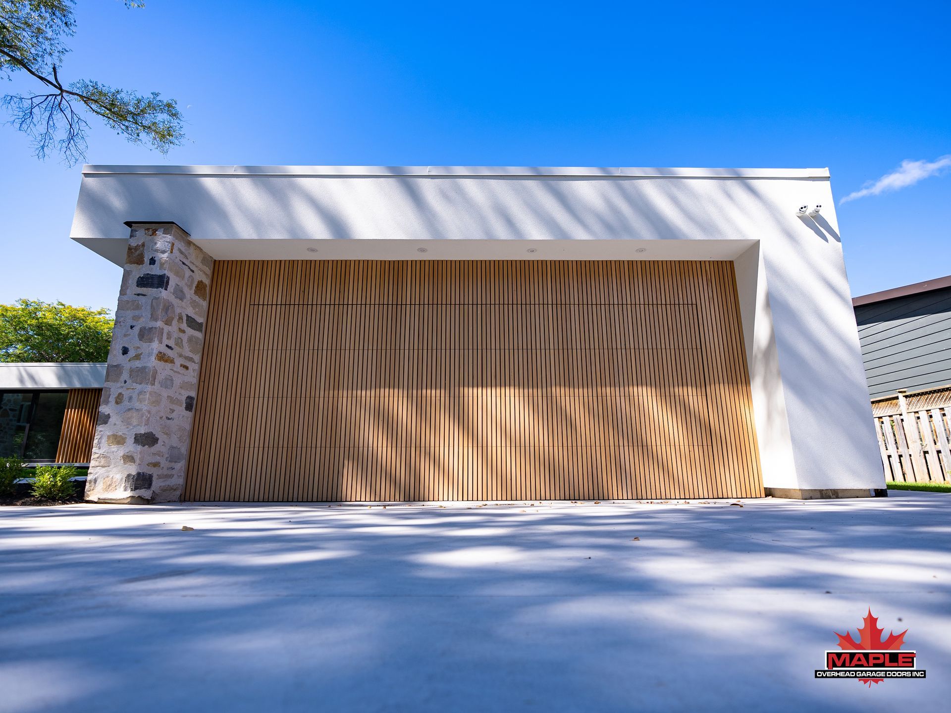 A white house with a wooden garage door