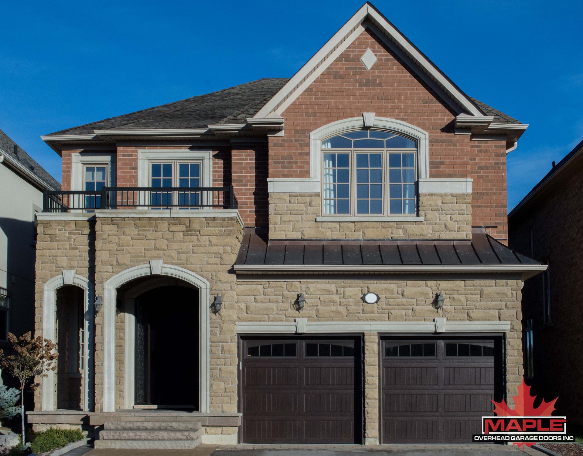 A large brick house with a maple logo on the front
