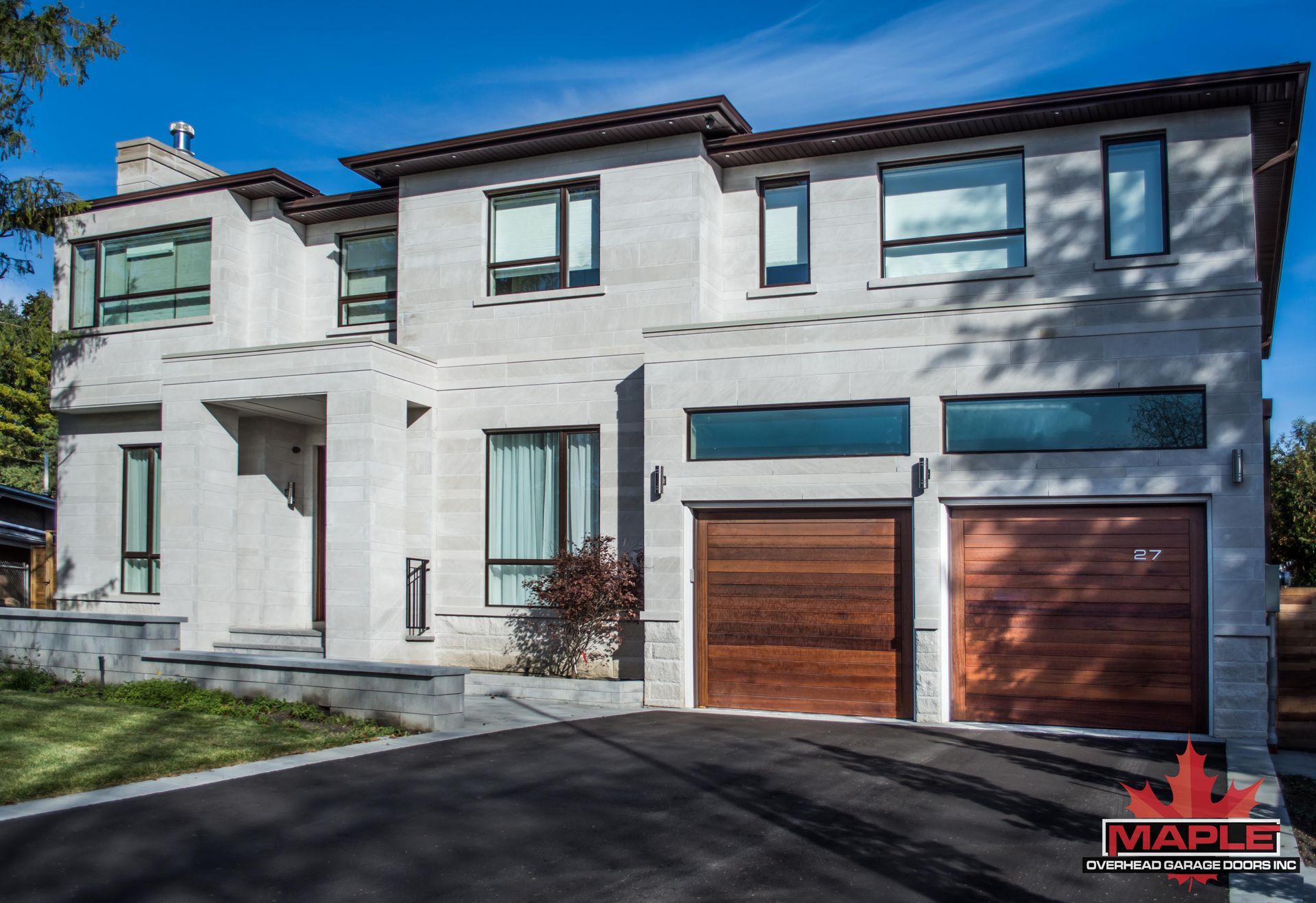 A large white house with a wooden garage door