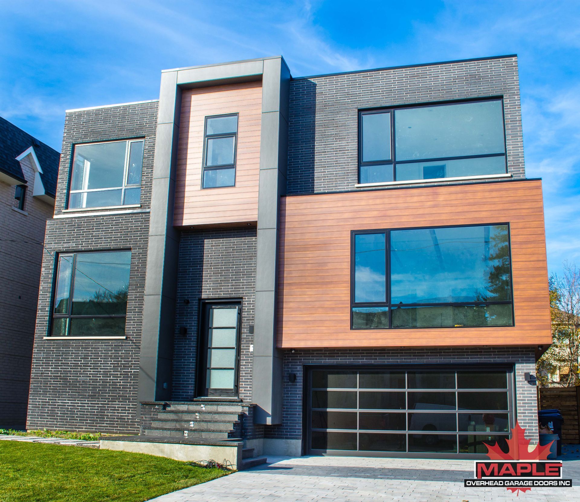 A modern house with a maple logo on the front
