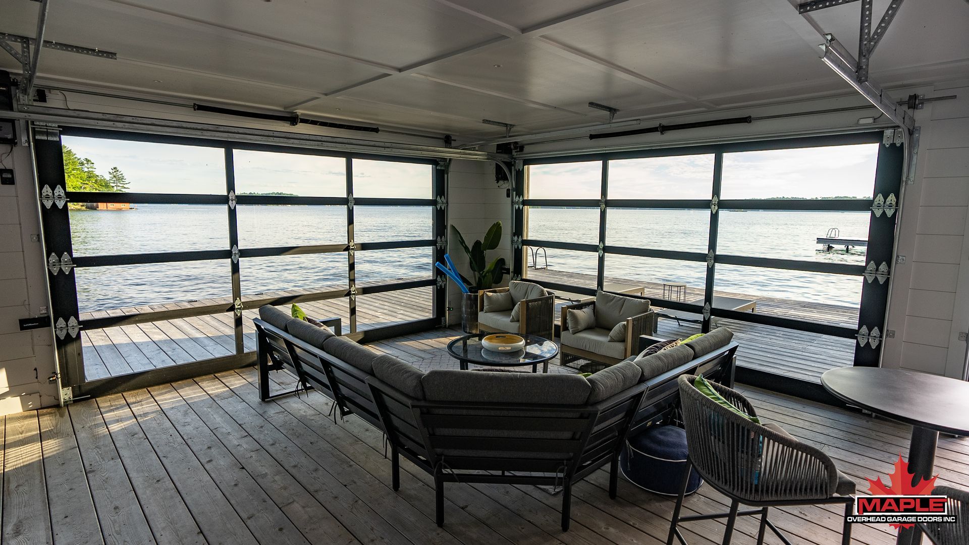 A living room with a lot of furniture and a view of the water.