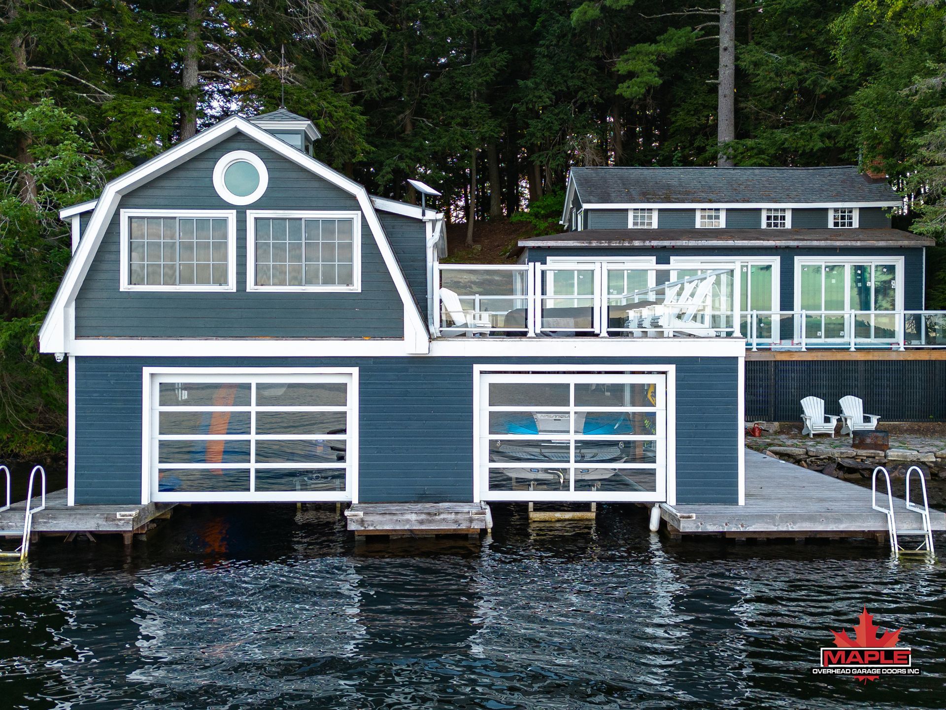 A house with a barn roof sits on top of a body of water