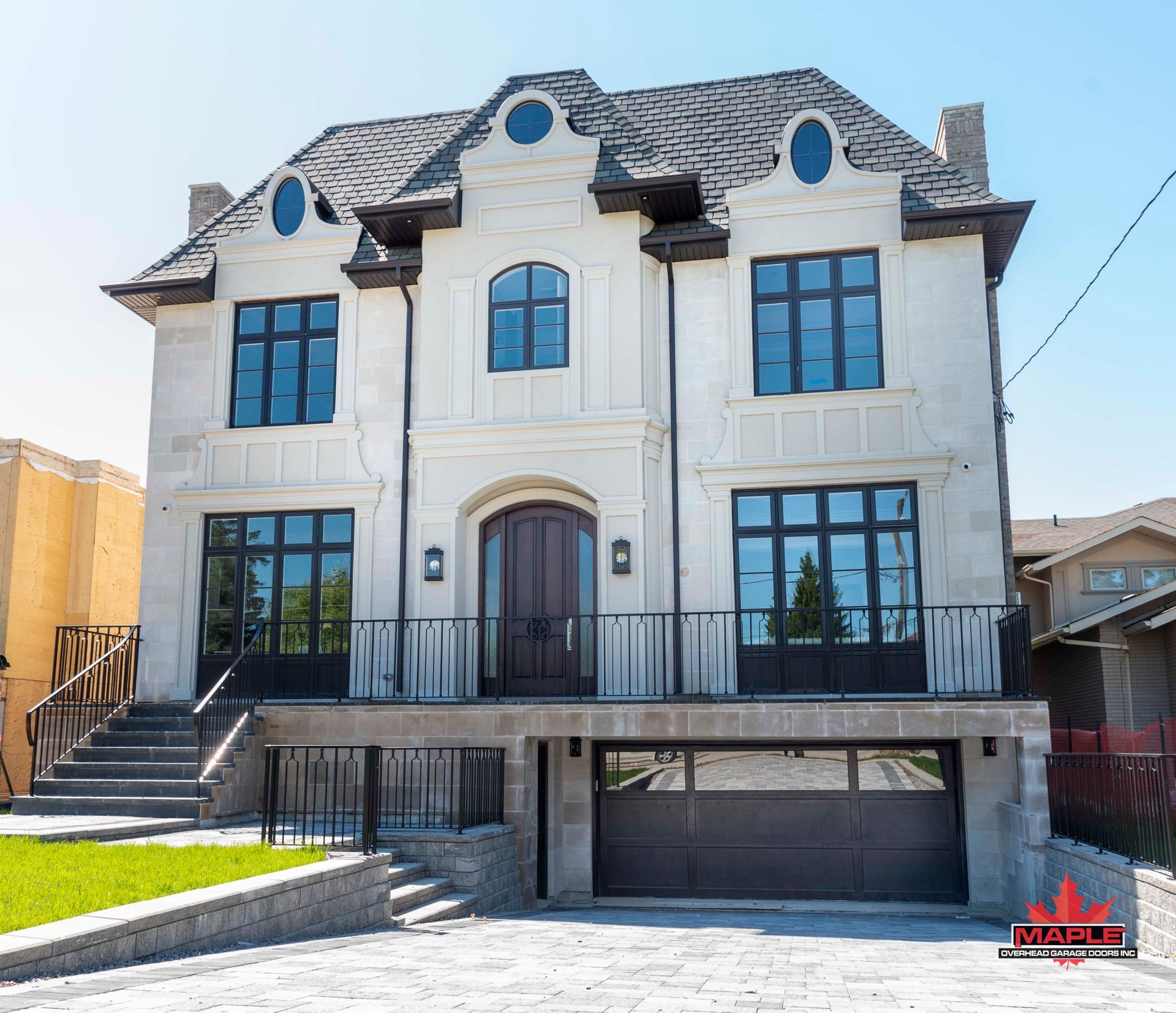 A large white house with a garage and stairs