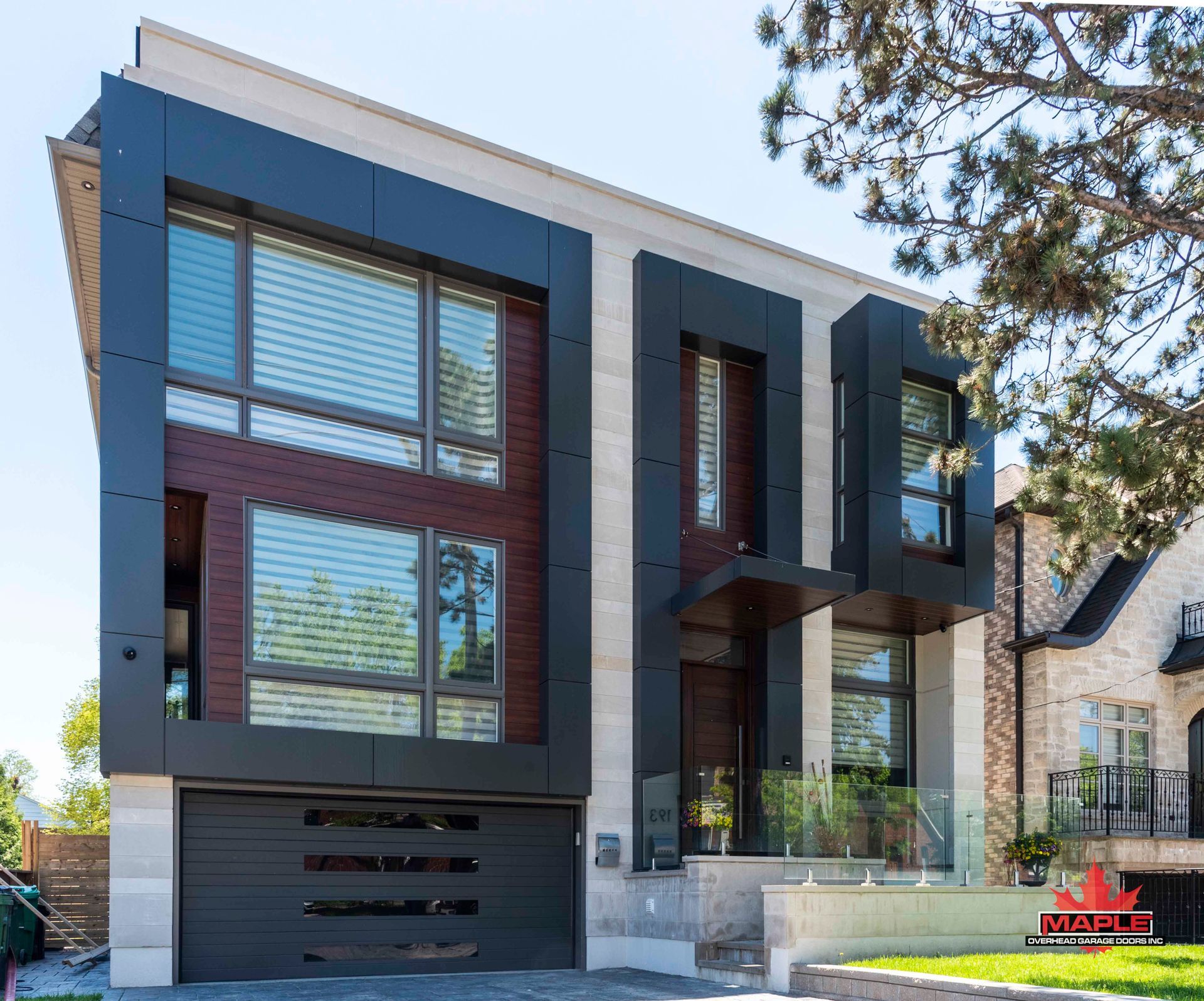 A modern house with a large garage and lots of windows