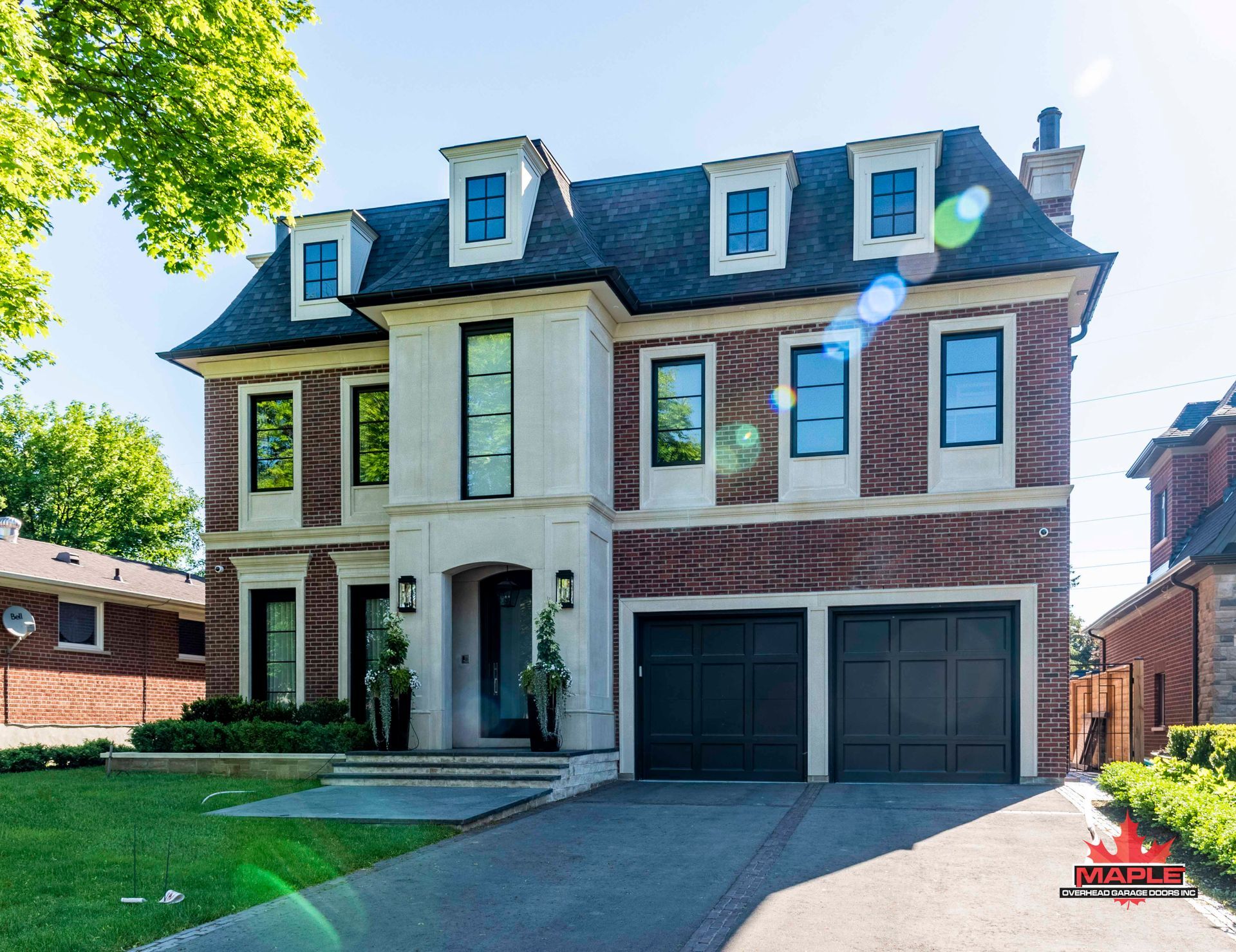 A large brick house with a black garage door