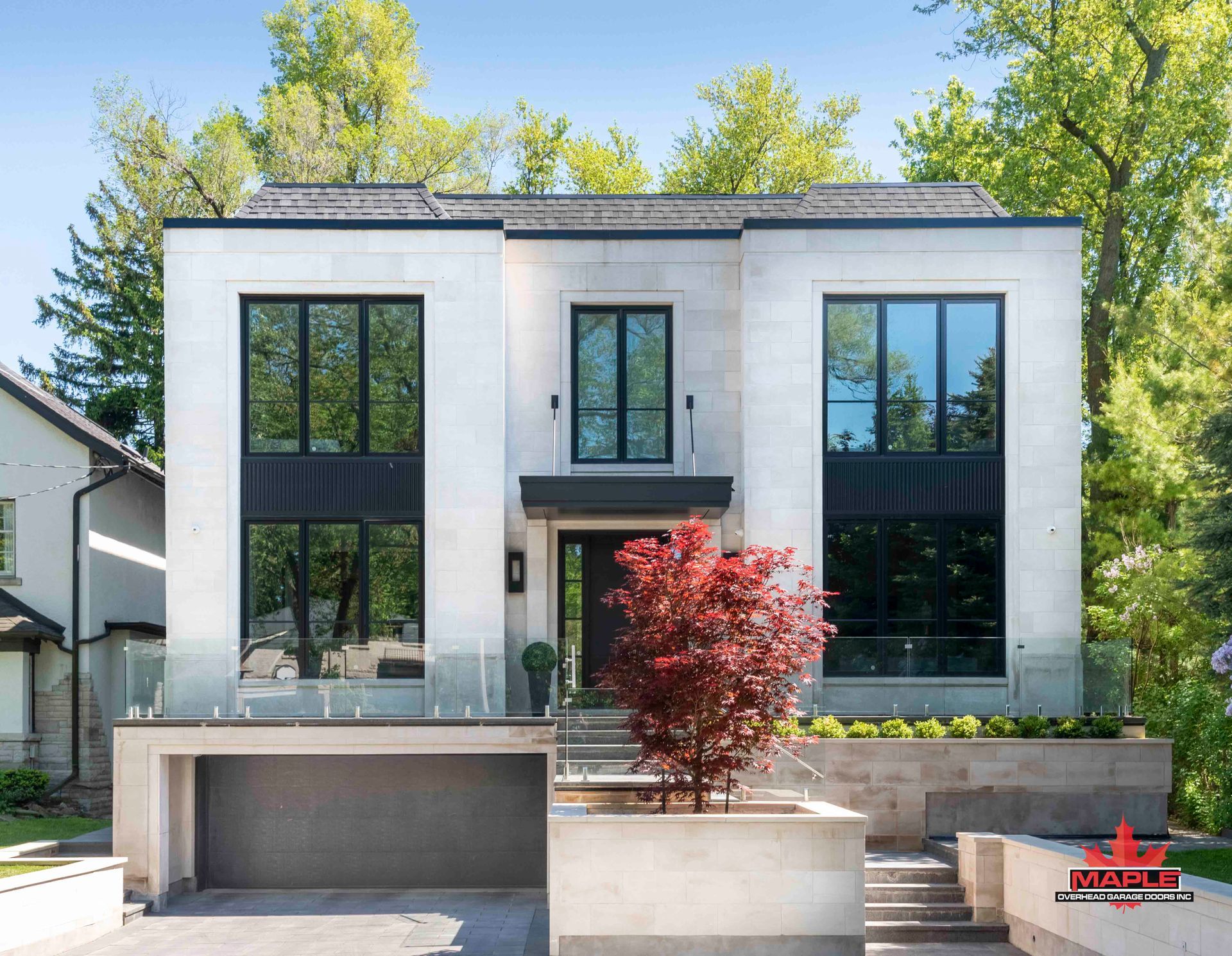A large white house with a tree in front of it