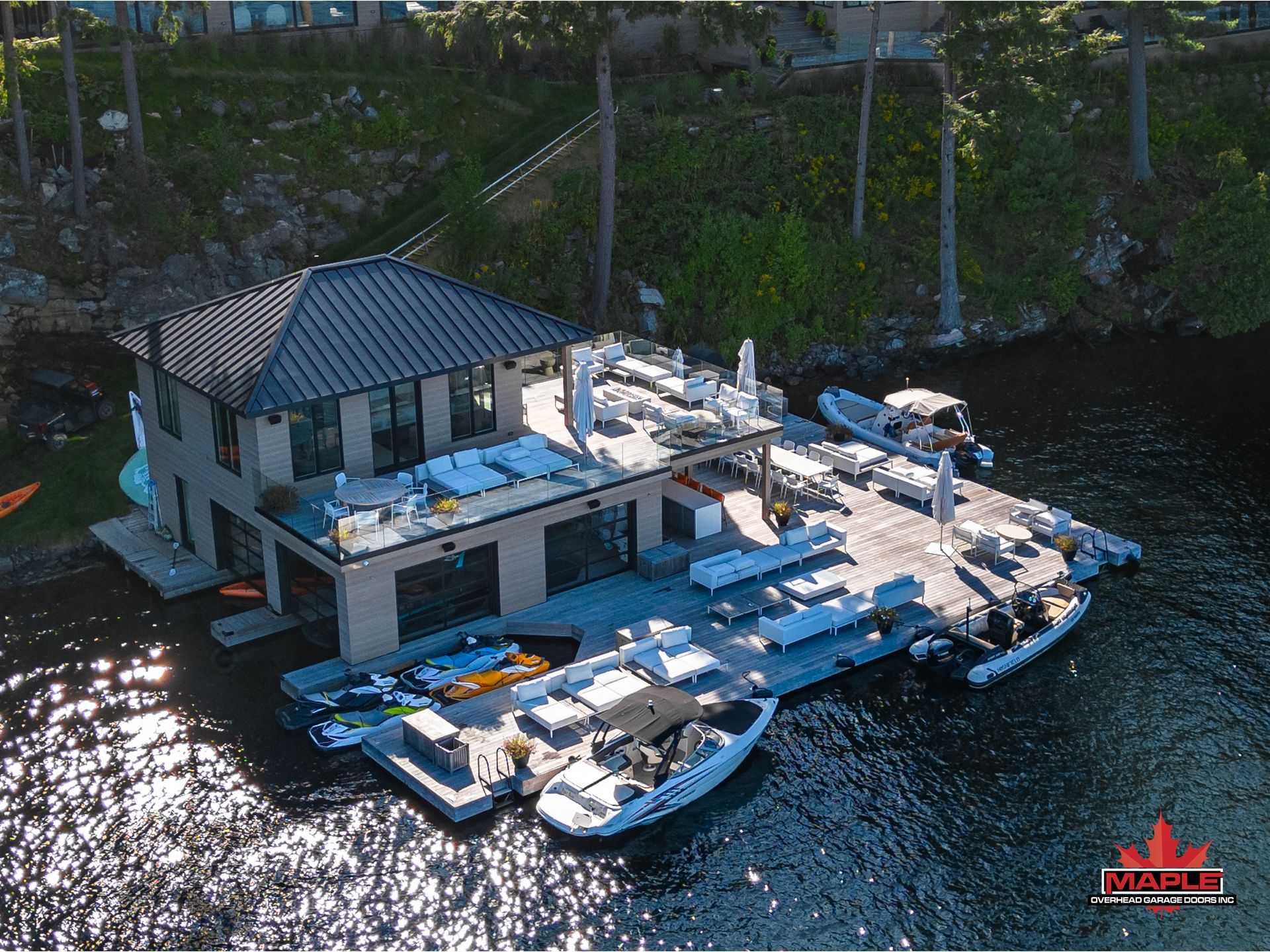 An aerial view of a dock filled with boats and a house