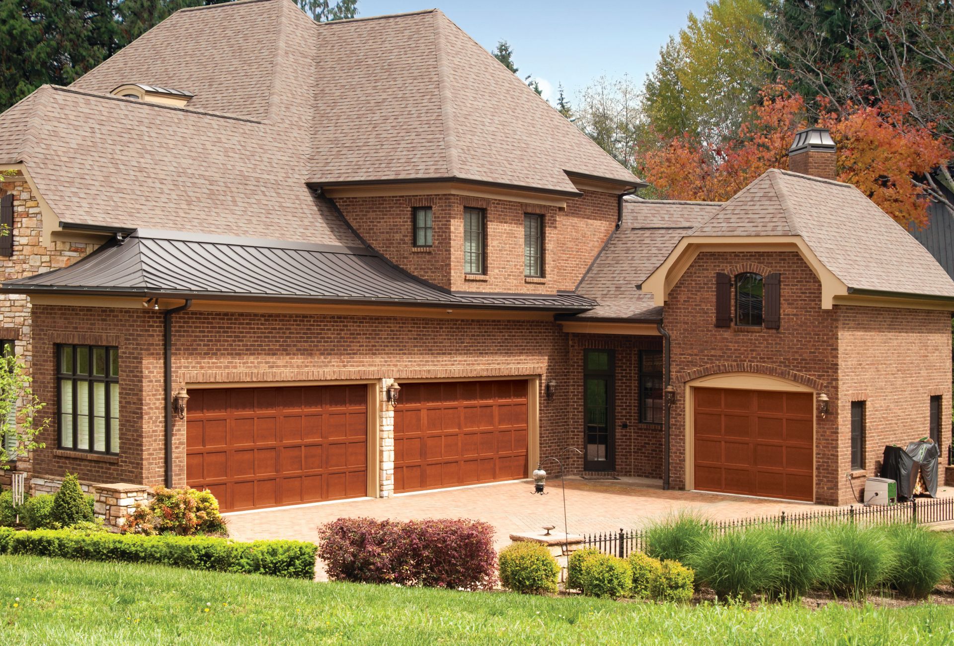 A large brick house with three garage doors