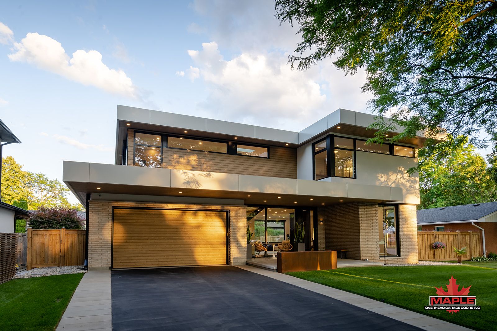 A modern house with a large garage and a driveway.