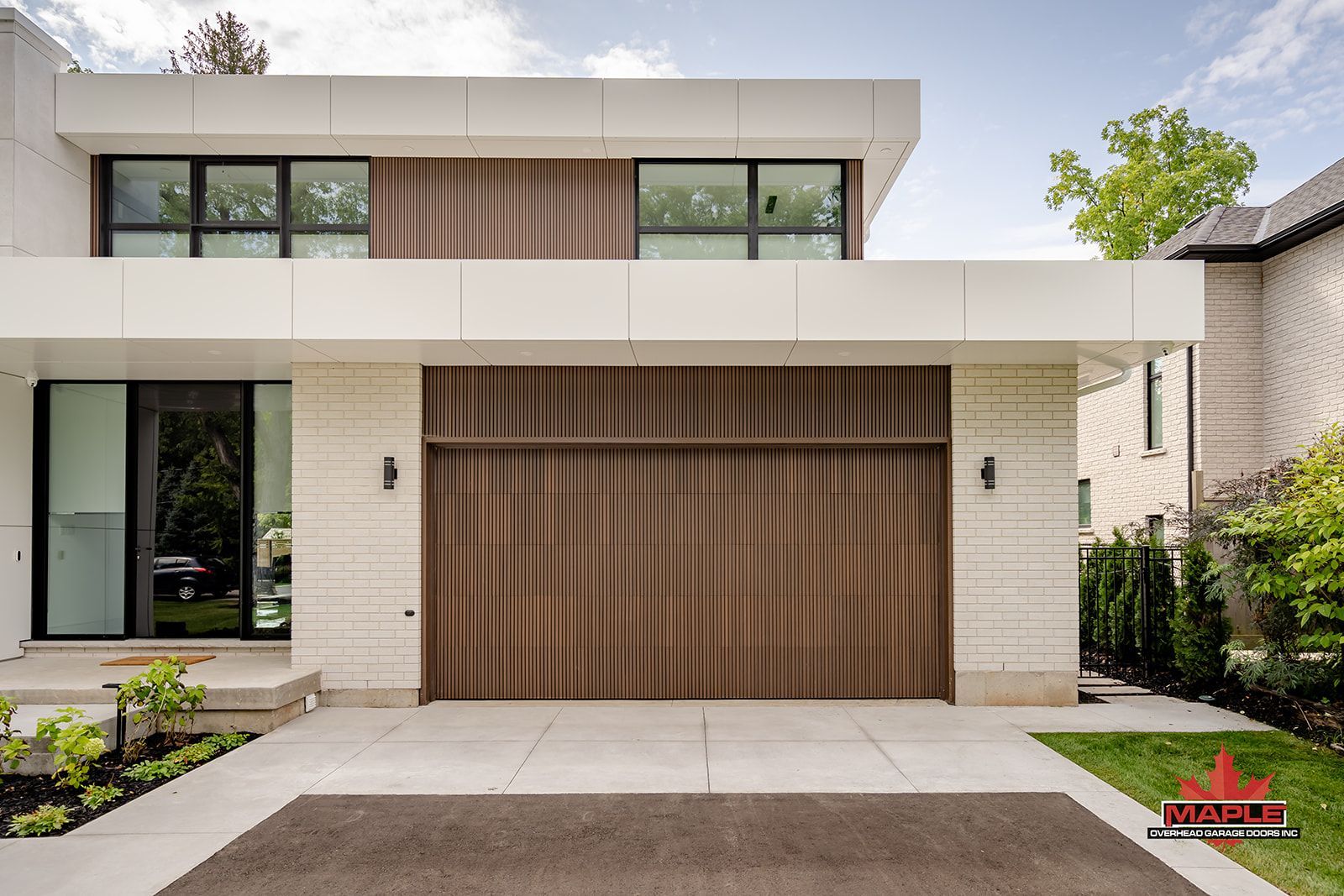 A modern white house with a brown garage door