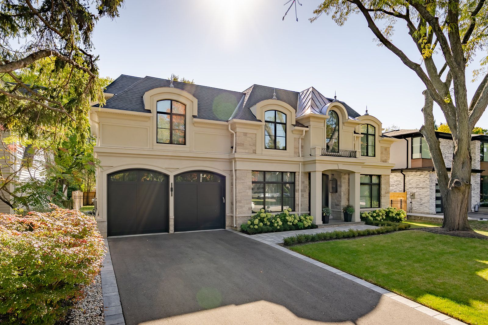 A large house with two garages and a driveway