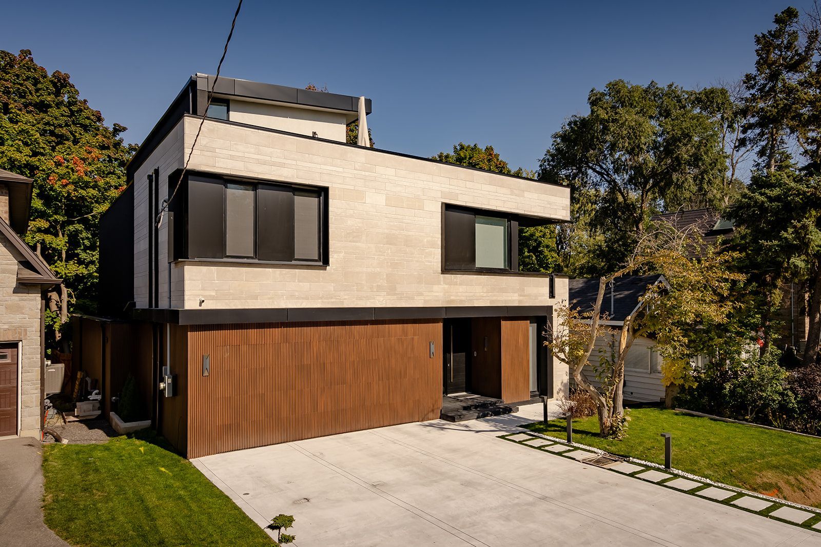 A modern house with a large garage and a driveway