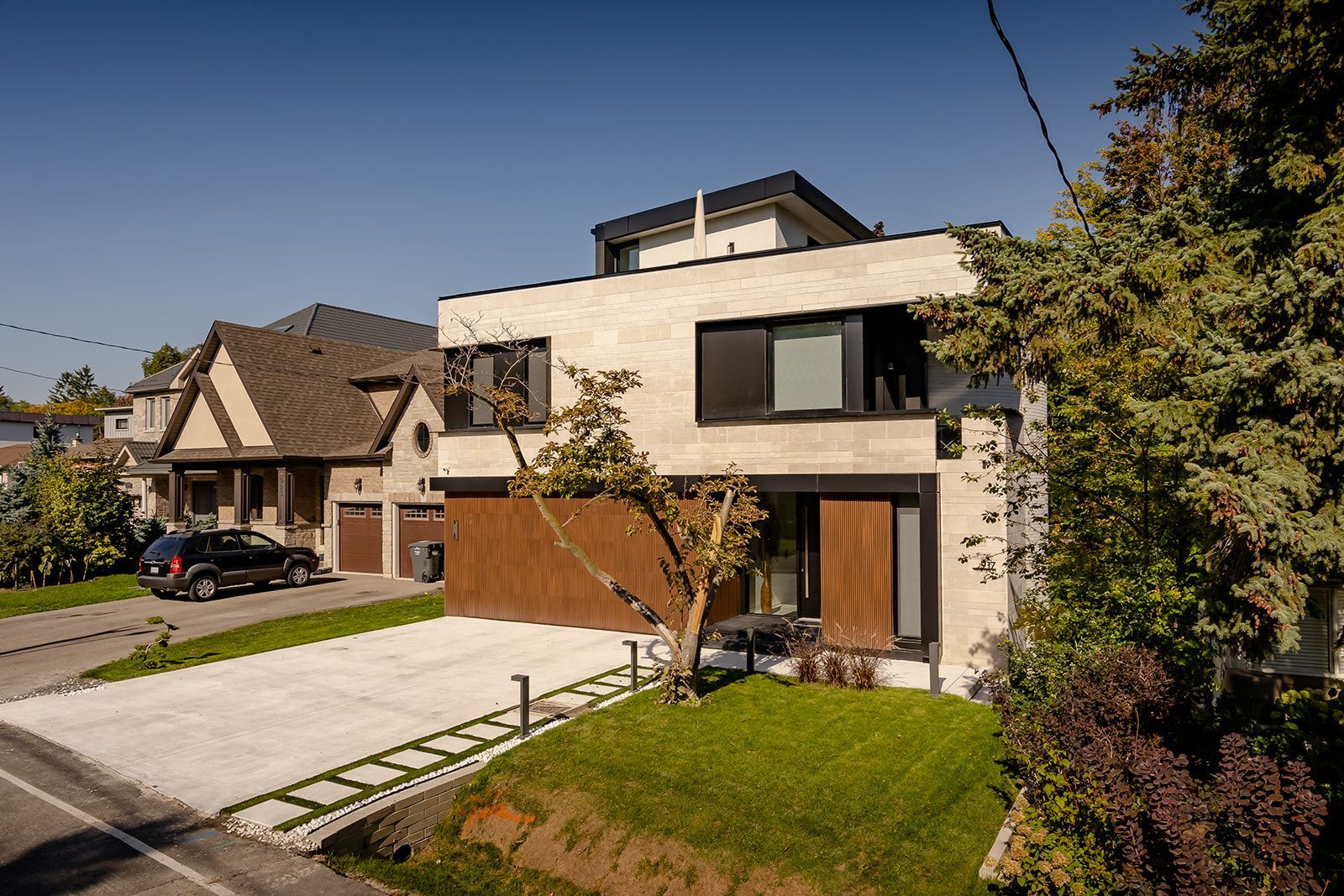A house with a car parked in front of it in a residential area.