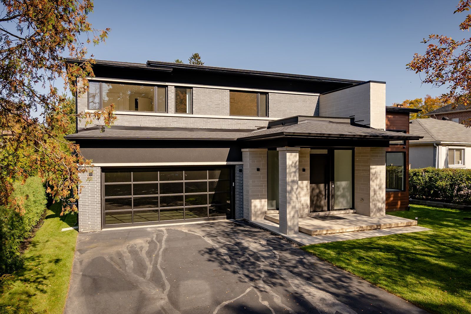 A large house with a garage and a driveway in front of it.