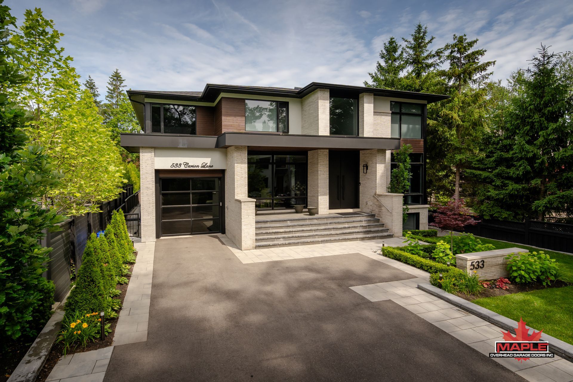A modern house with a large driveway in front of it