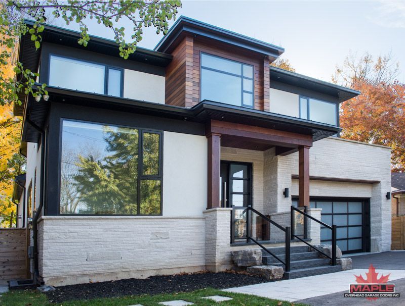 A modern house with a lot of windows and stairs