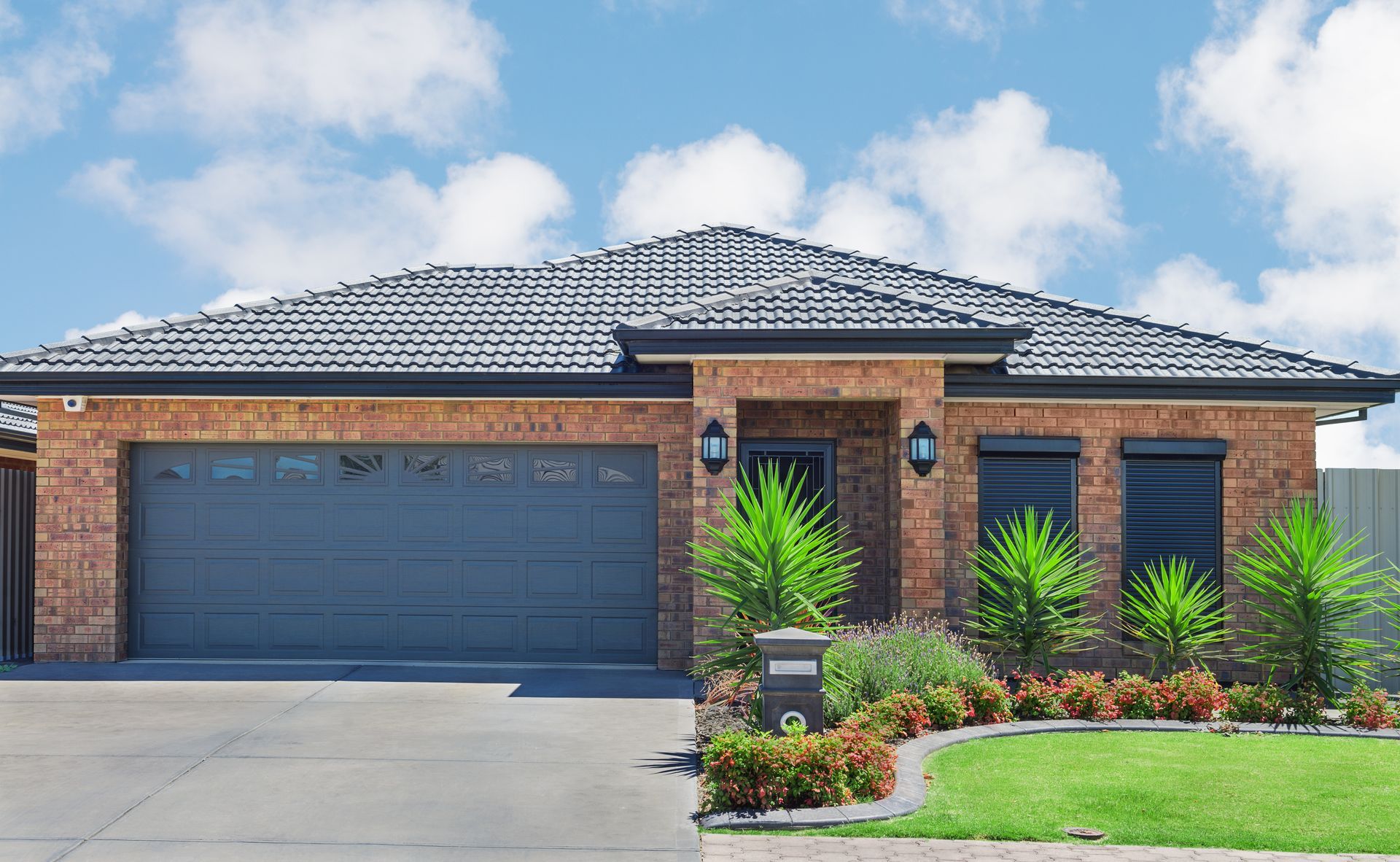 A large brick house with a gray garage door