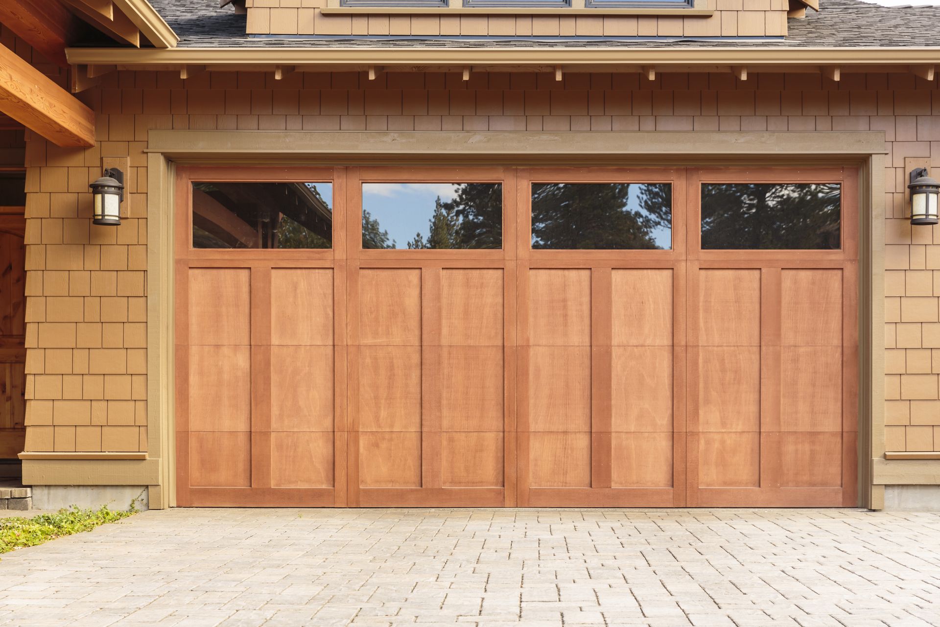 The garage door is made of wood and has a lot of windows