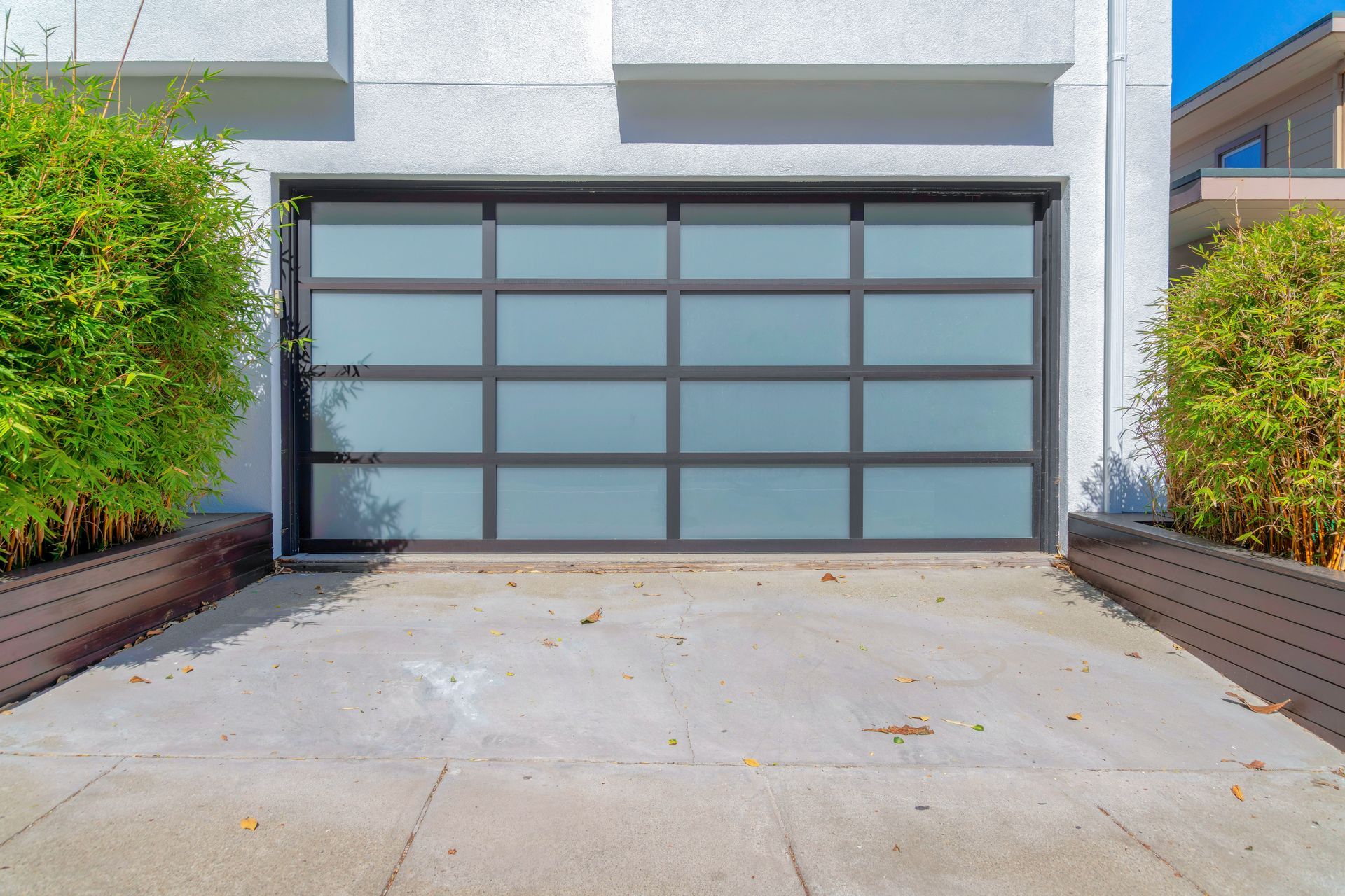 A white house with a large glass garage door.
